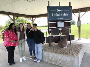 Smiling group of people in front of New Philadelphia site. 