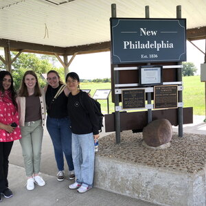 Smiling group of people in front of New Philadelphia site. 